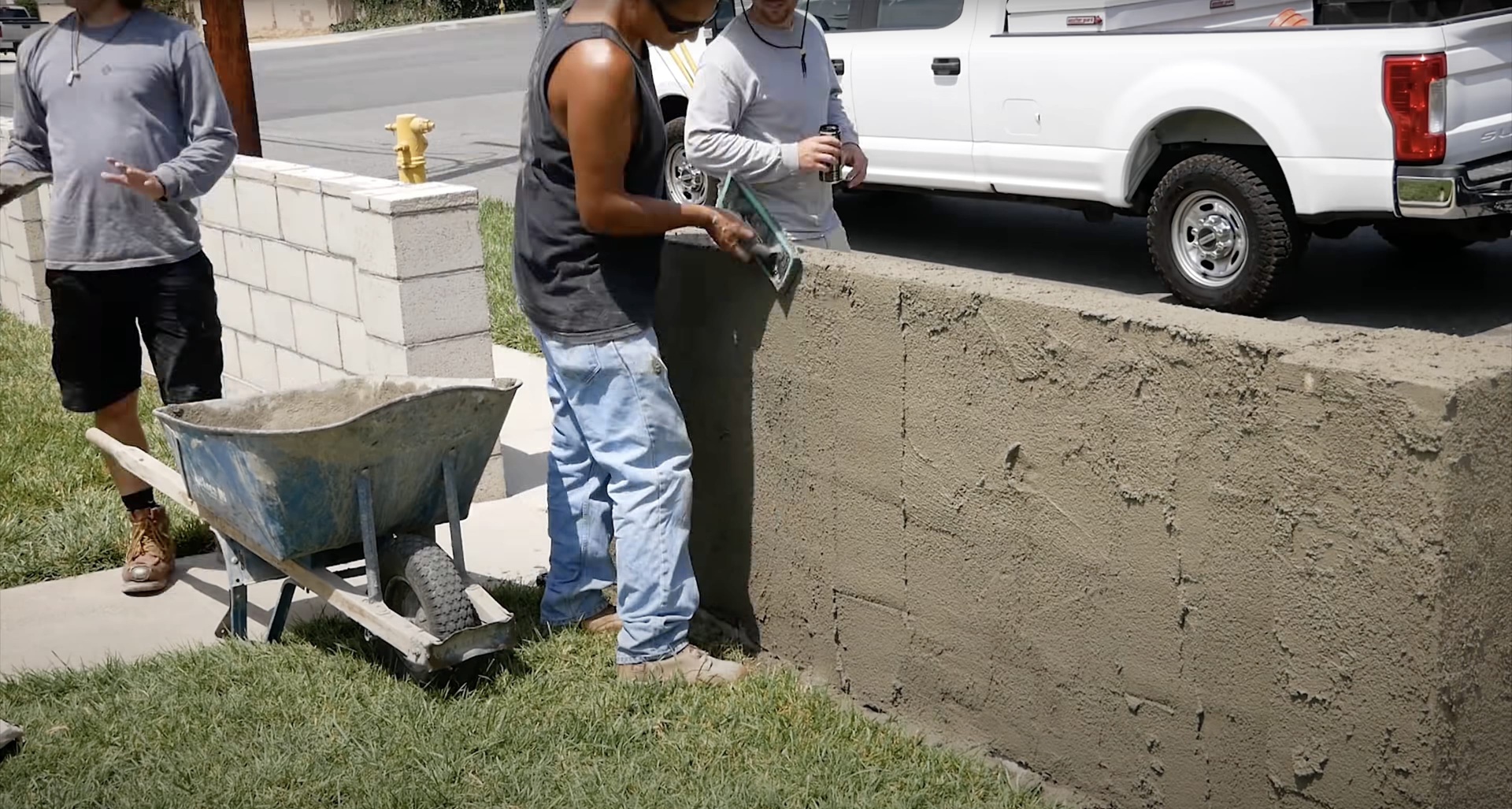 Professional concrete mixing and installation by skilled workers Concrete contractors mixing and pouring concrete for sidewalk installation