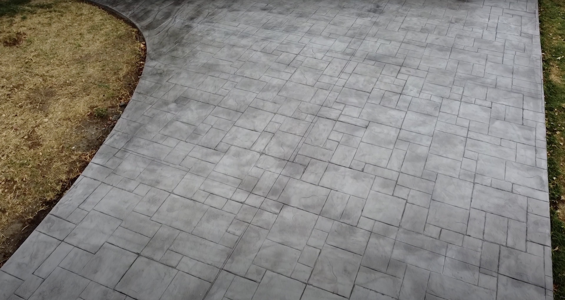 Detailed stamped concrete patio with professional texture finishing Close-up view of stamped concrete patio showing detailed texture and pattern work