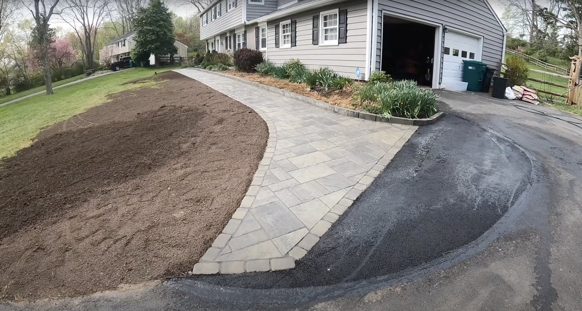 Custom curved stamped concrete walkway with decorative paver pattern Curved stamped concrete walkway connecting driveway to home entrance